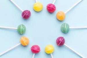 Sweet lollipops on blue background photo