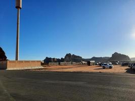 A beautiful daytime view of a winter park in Al Ula, Saudi Arabia. The park is surrounded by ancient hills. photo