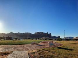 A beautiful daytime view of a winter park in Al Ula, Saudi Arabia. The park is surrounded by ancient hills. photo