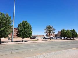 A beautiful daytime view of a winter park in Al Ula, Saudi Arabia. The park is surrounded by ancient hills. photo