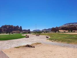 A beautiful daytime view of a winter park in Al Ula, Saudi Arabia. The park is surrounded by ancient hills. photo