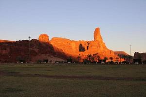 A beautiful daytime view of a winter park in Al Ula, Saudi Arabia. The park is surrounded by ancient hills. photo