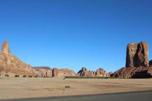 A beautiful daytime view of a winter park in Al Ula, Saudi Arabia. The park is surrounded by ancient hills. photo