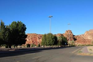 A beautiful daytime view of a winter park in Al Ula, Saudi Arabia. The park is surrounded by ancient hills. photo