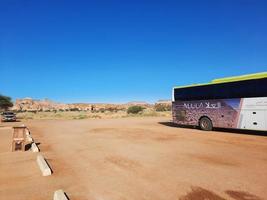 Al Ula, Saudi Arabia, March 2023 - Buses are parked at different places in the desert to take tourists to different places during the day in Al Ula, Saudi Arabia. photo