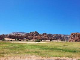 A beautiful daytime view of a winter park in Al Ula, Saudi Arabia. The park is surrounded by ancient hills. photo