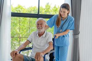 Elderly man talk to doctors and nurses in the hospital. senior male happy after receiving treatment and care and practice walk from a professional doctor. health care, physical therapy, nursing home photo