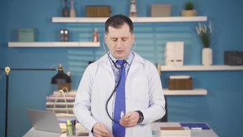 Male doctor examining his imaginary patient looking at camera with a stethoscope. Holding stethoscope to camera and examining looking at camera, Health treatment. video