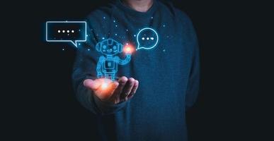 A person stretches out his hand with a model of a robot on his palm. Demonstrates the use of ai and chat GPT systems to research and work. photo