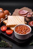 Delicious canned beans in a tomato in a white ceramic bowl photo