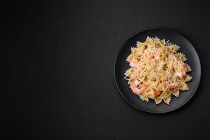 Delicious farfalle pasta with langoustine shrimp with creamy sauce photo