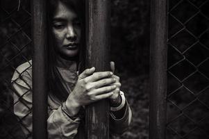 Portrait of women desperate to catch the iron prison,prisoner concept,thailand people,Hope to be free,If the violate the law would be arrested and jailed. photo