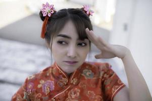 Portrait beautiful asian woman in Cheongsam dress,Thailand people,Happy Chinese new year concept,Happy  asian lady in chinese traditional dress photo