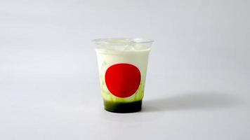 Iced green tea red mark on plastic cup white background. photo