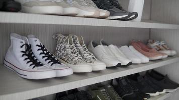 Shelves with different types of sports shoes. Shallow depth of field. photo