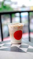 Iced coffee in plastic cup with red mark at the front cup photo