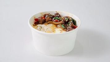 Stir-fried beef with chili sauce in a white bowl on a white background photo