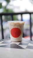 Iced coffee in plastic cup with red mark at the front cup photo