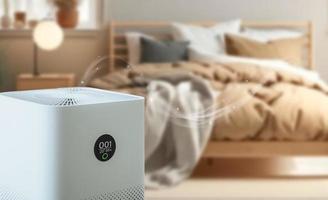 air purifier a bed room,  air cleaner removing fine dust in house. protect PM 2.5 dust and air pollution concept photo