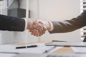 Support, business people, happy asian young man in suit, making handshake, shake hand together with partnership, customer or colleague after is done, successful. Worker meeting, congrats merger. photo