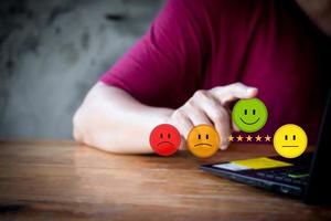 Customer service evaluation and feedback concept. best excellent business rating experience. Business people touching the virtual screen on the happy Smiley face icon Satisfaction survey concept. photo