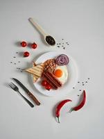 English Breakfast - fried egg, tomatoes and sausage on White Background. Top view. Copy space for text photo