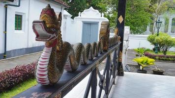 decorative statue of a dragon head snake in the courtyard of the Yogyakarta palace building photo