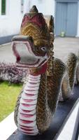 decorative statue of a dragon head snake in the courtyard of the Yogyakarta palace building photo