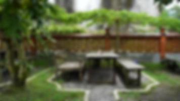 blurred background of  table reservation no 6, ordered at raminten restaurant yogyakarta indonesia in the garden area. photo