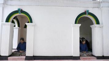 a statue of a royal guard sitting cross-legged in front of the royal door photo