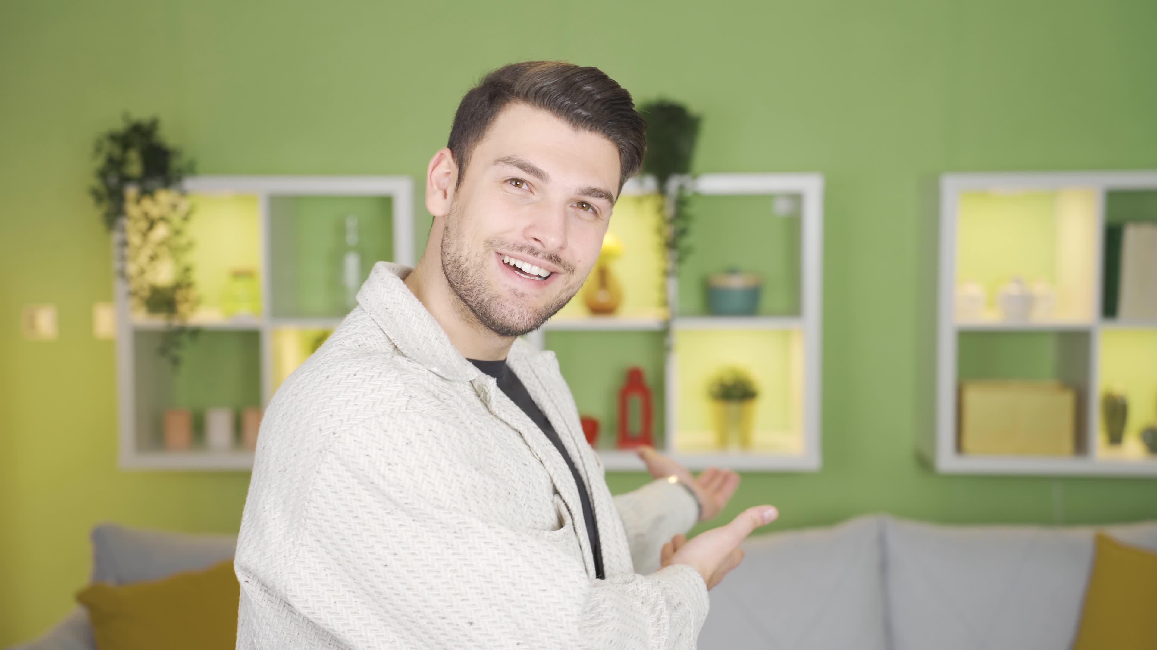 The young man saying something towards the camera signals him to come