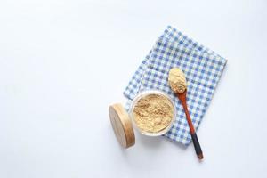 coconut sugar in a jar on white background photo