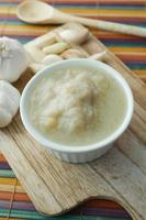 garlic paste in a bowl on table photo