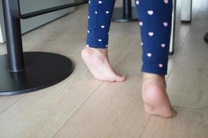 low angle view of A child walking on tiptoes photo