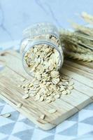 roasted oats flakes spilling on table photo