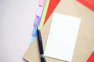 weekly planner and notepad on table photo