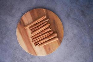 Cinnamon sticks on a chopping board photo