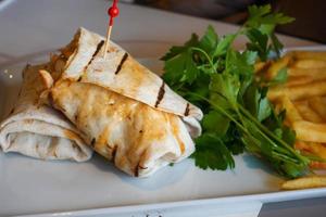 chicken warp and fresh salad on table photo