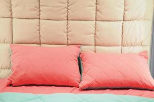 pink color pillow lined up on bed photo