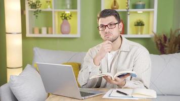 Diligent student doing research. Student doing homework.  Young student who is satisfied and happy with his job. video