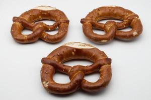 Brezel, also known as a pretzel, is a type of baked bread product often associated with German cuisine. photo