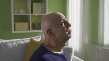 Thoughtful, depressed and lonely old man has mental health and psychological disorder at home. video