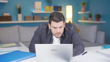 Serious and focused working man gets angry at what he sees on the screen. The man works from the laptop, focused on his work, and then begins to get annoyed by what he sees on the laptop screen. video