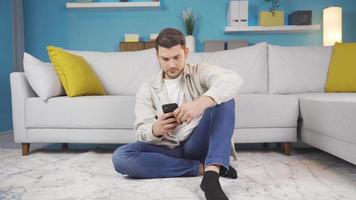 The man dealing with the phone receives the news that he will be happy and expresses his happiness by looking at the camera. video