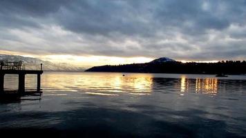 snow mountain lake sunset on a cloudy day, landscape video
