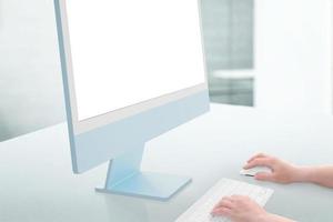 Blue display mockup on a clean white background with keyboard and mouse beside. Side view photo