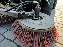 Close-up sweeper machine cleaning. Concept clean streets from debris. photo