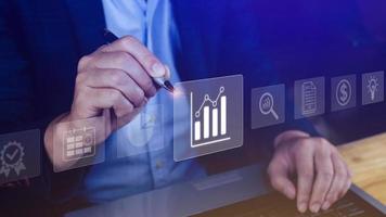 Big data analytics and business intelligence BI concept with chart and graph icons on digital screen interface and business people in the background. photo