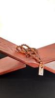 Tasbih lying on the table to read the Quran. photo