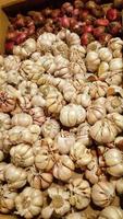 Garlic on a shelf for sale in a traditional market. photo